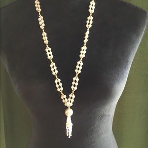 Over the head costume pearl and gold necklace.